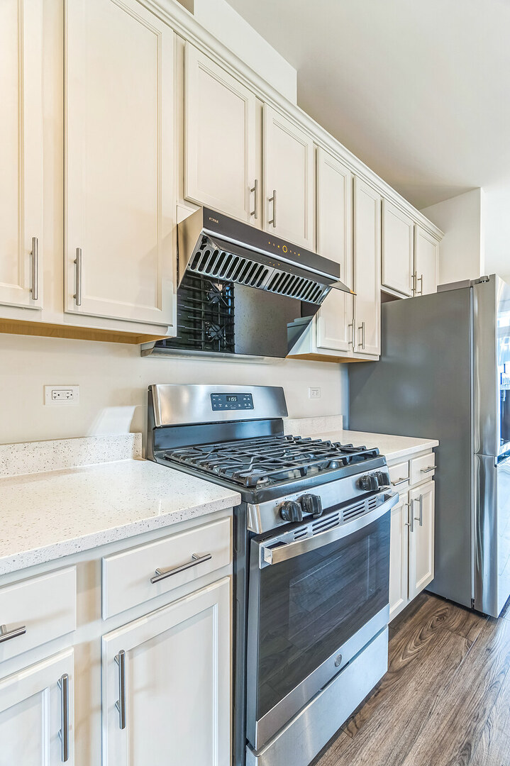 4138 Irving Road Aurora, IL 60504 - Photo 8 of 32 a kitchen with granite countertop a stove and a sink