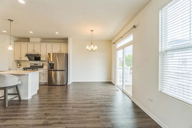 a view of kitchen with refrigerator microwave and wooden floor