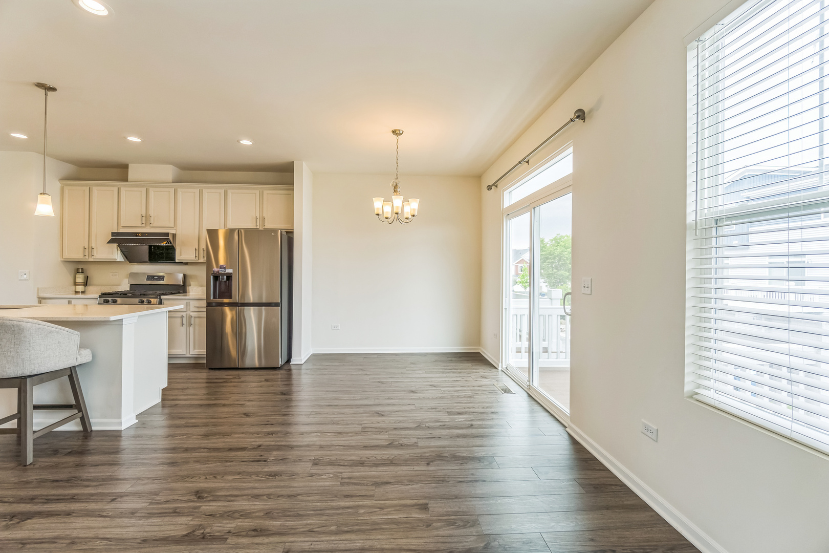 4138 Irving Road Aurora, IL 60504 - Photo 9 of 32 a view of kitchen with refrigerator microwave and wooden floor