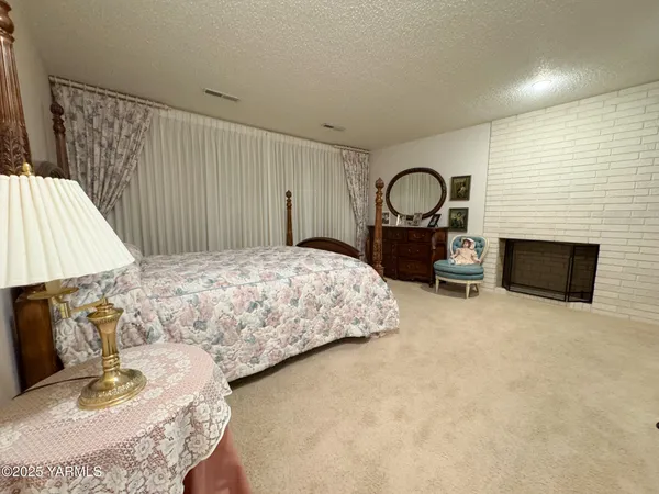 a bedroom with a bed and a fireplace