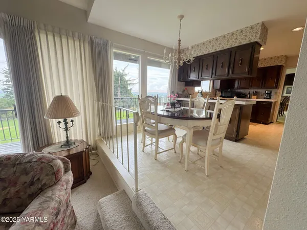 a view of a dining room with furniture window and outside view