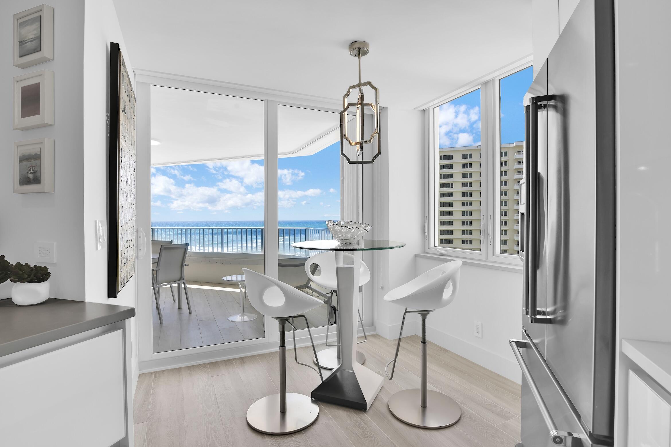 550 South Ocean Boulevard, Unit 1004 Boca Raton, FL 33432 - Photo 16 of 74 a dining room with wooden floor table and chairs