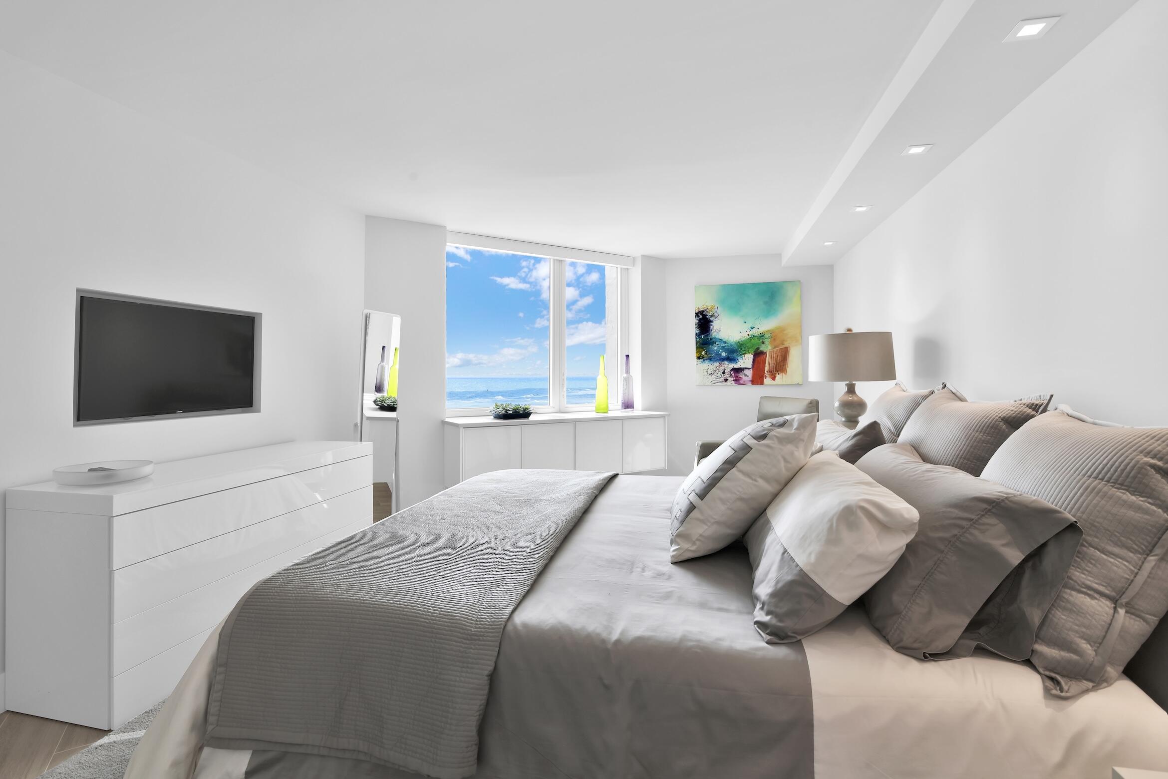 550 South Ocean Boulevard, Unit 1004 Boca Raton, FL 33432 - Photo 17 of 74 a bedroom with a bed and a flat screen tv