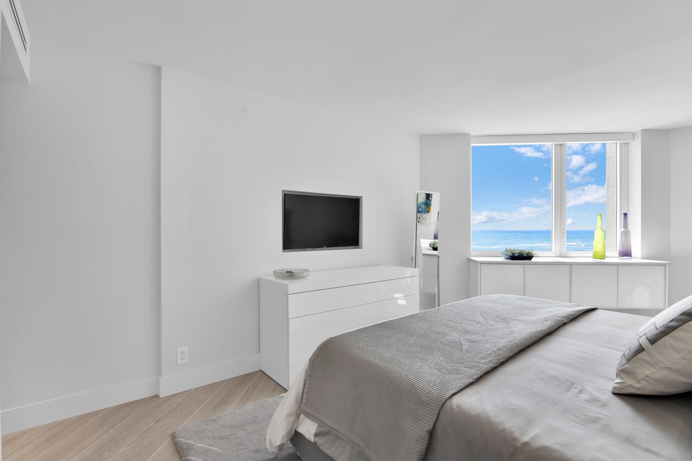 550 South Ocean Boulevard, Unit 1004 Boca Raton, FL 33432 - Photo 18 of 74 a bedroom with a bed and a flat screen tv