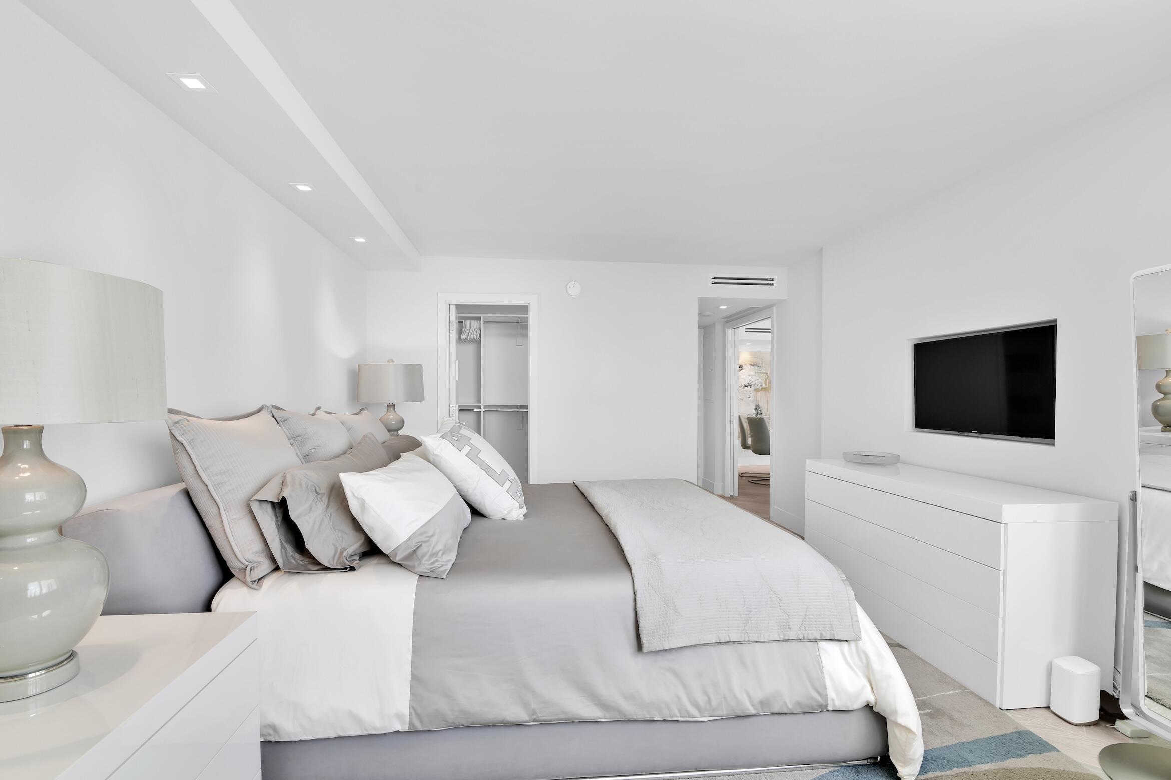 550 South Ocean Boulevard, Unit 1004 Boca Raton, FL 33432 - Photo 19 of 74 a bedroom with a bed and a flat screen tv