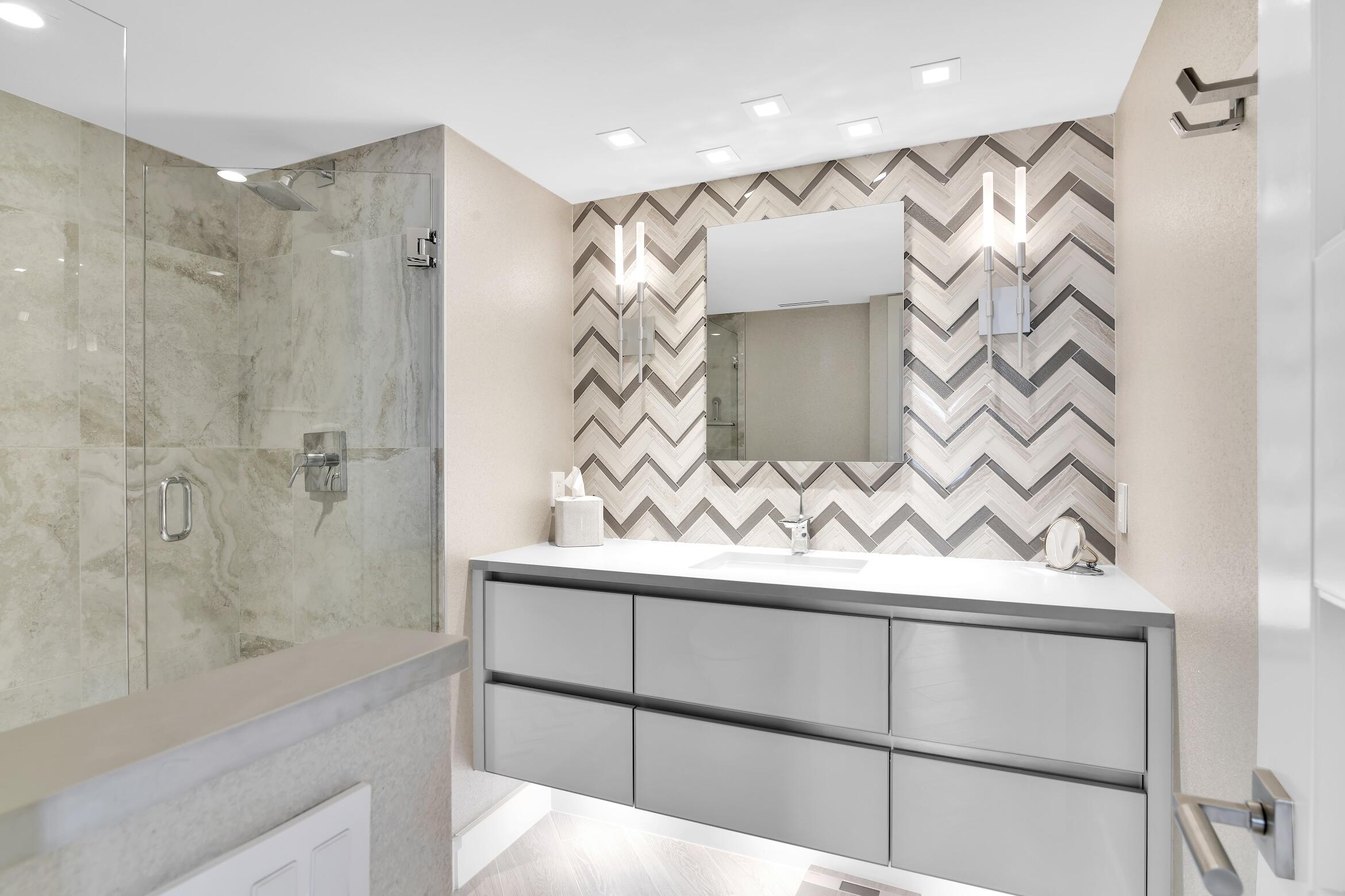 550 South Ocean Boulevard, Unit 1004 Boca Raton, FL 33432 - Photo 21 of 74 a bathroom with a shower and a vanity