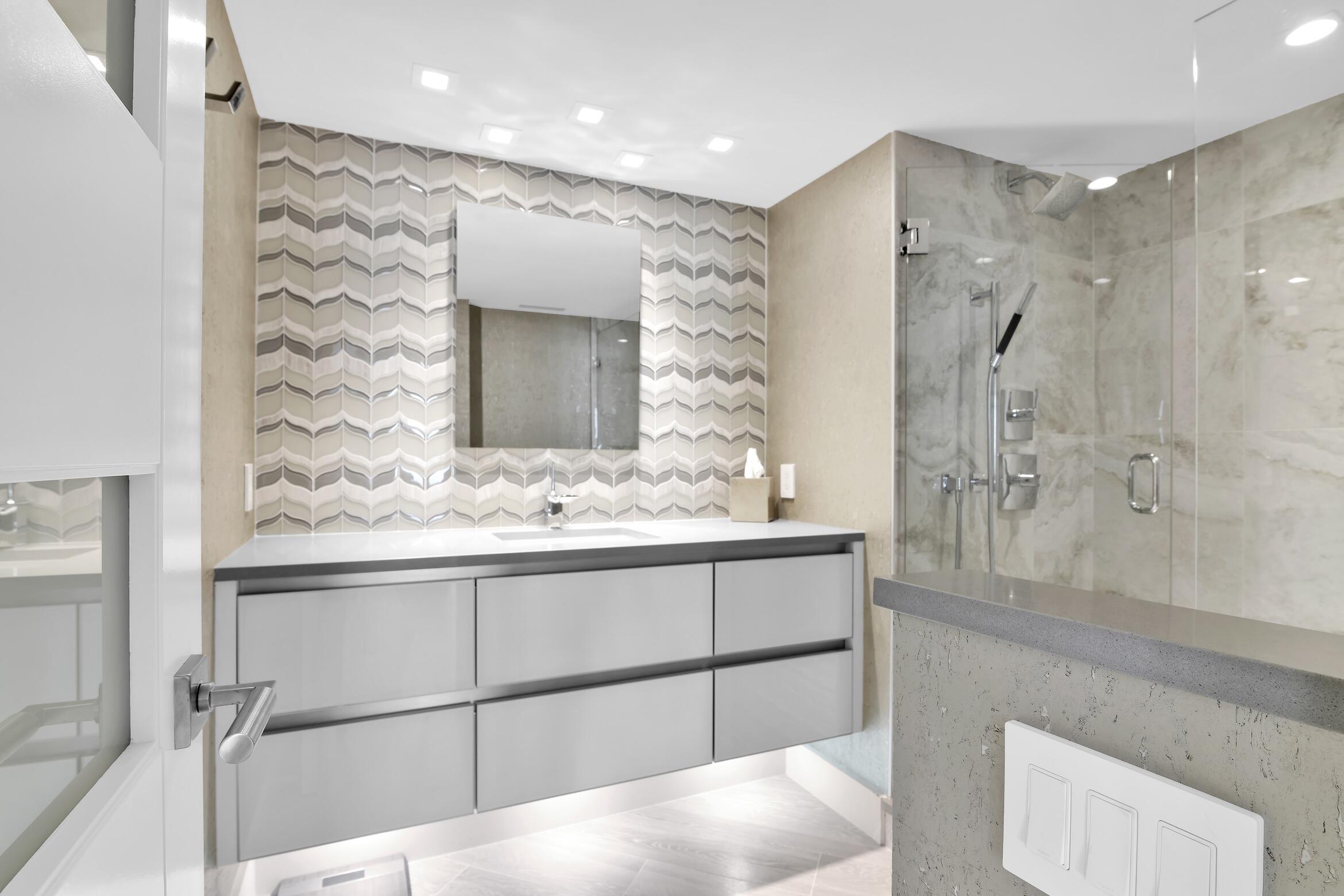 550 South Ocean Boulevard, Unit 1004 Boca Raton, FL 33432 - Photo 26 of 74 a bathroom with a sink and a mirror