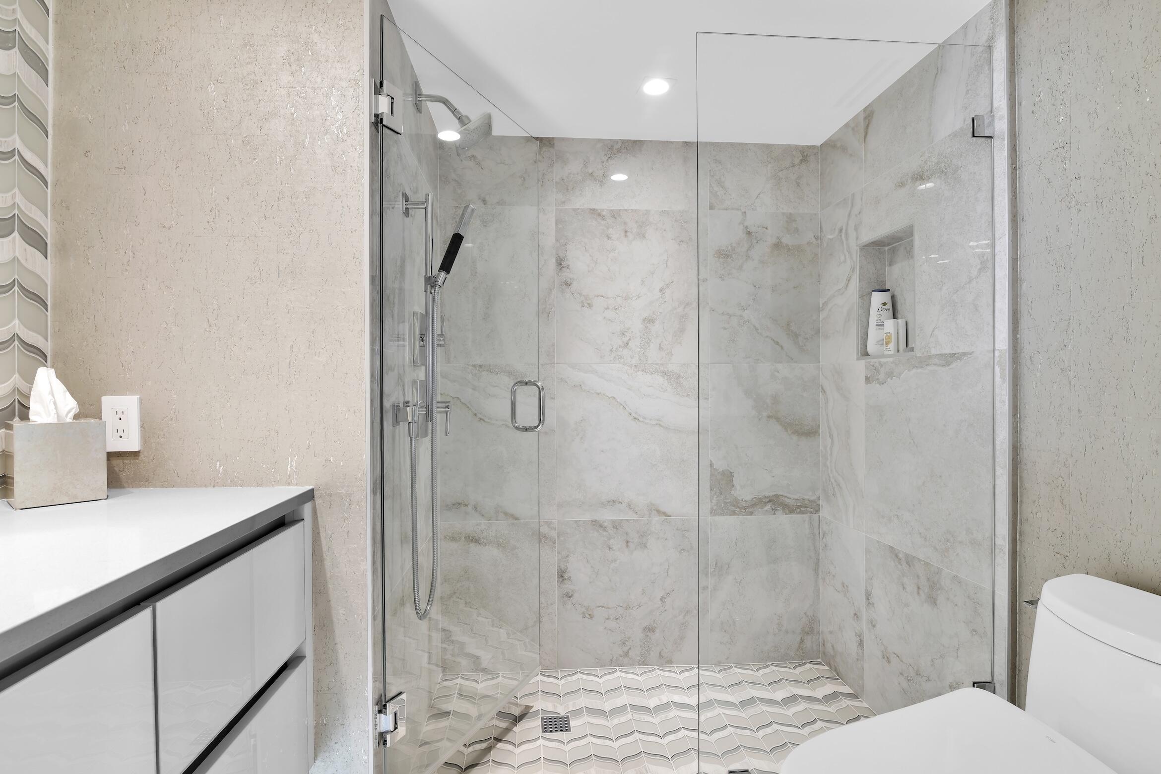 550 South Ocean Boulevard, Unit 1004 Boca Raton, FL 33432 - Photo 27 of 74 a bathroom with a granite countertop shower sink vanity and toilet