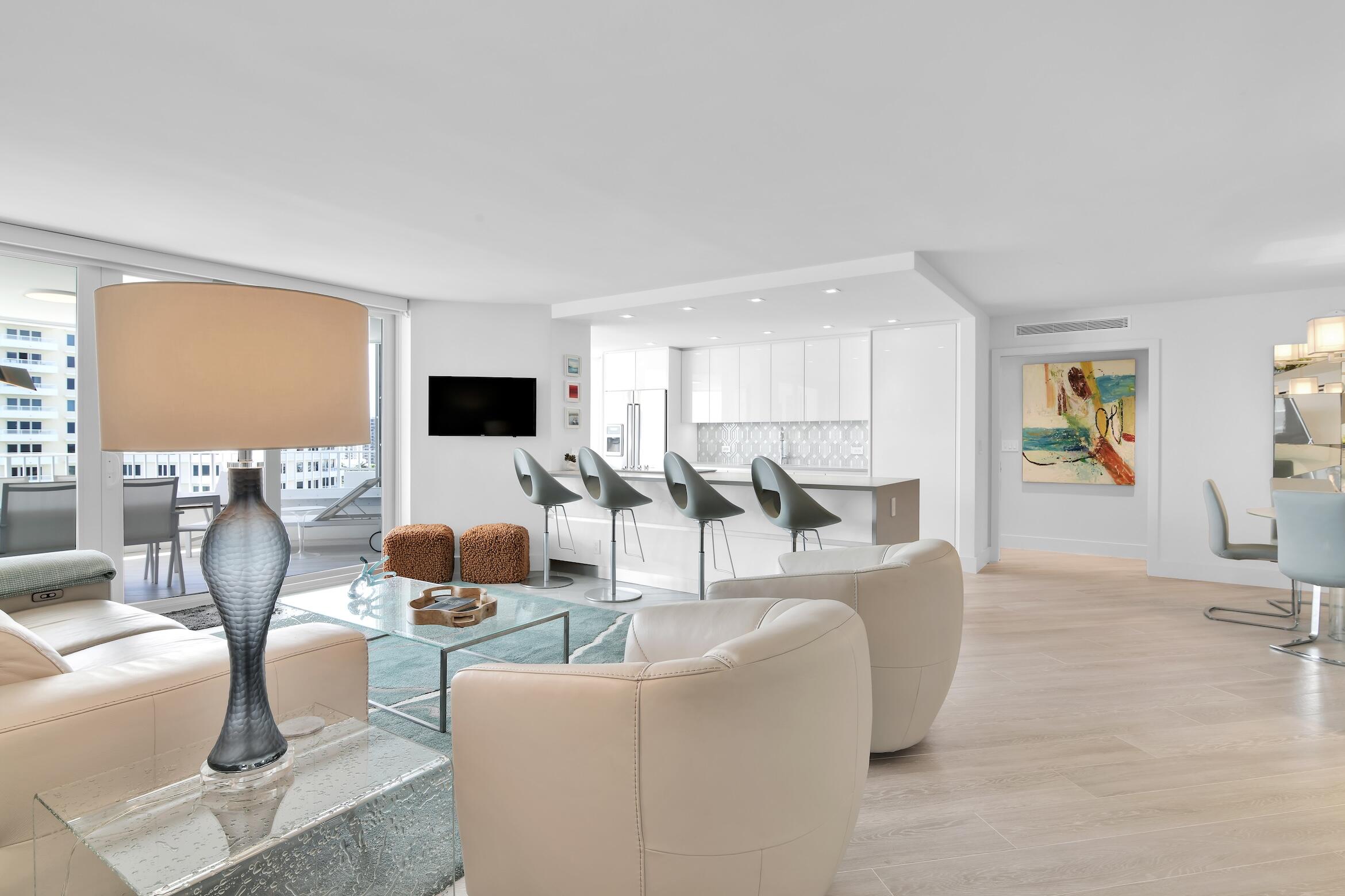 550 South Ocean Boulevard, Unit 1004 Boca Raton, FL 33432 - Photo 5 of 74 a living room with furniture and a flat screen tv