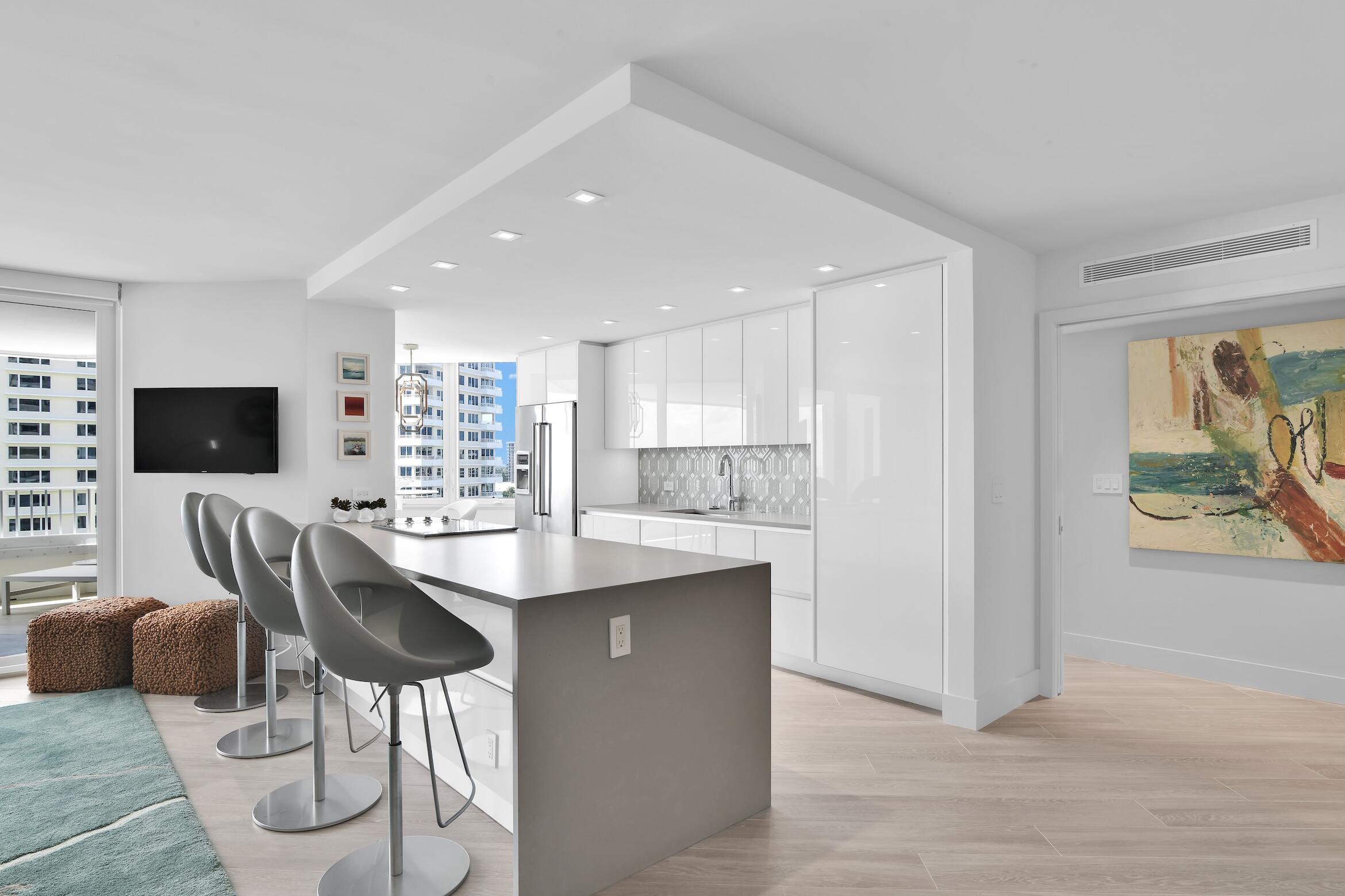 550 South Ocean Boulevard, Unit 1004 Boca Raton, FL 33432 - Photo 8 of 74 a kitchen with stainless steel appliances kitchen island granite countertop a sink and a refrigerator