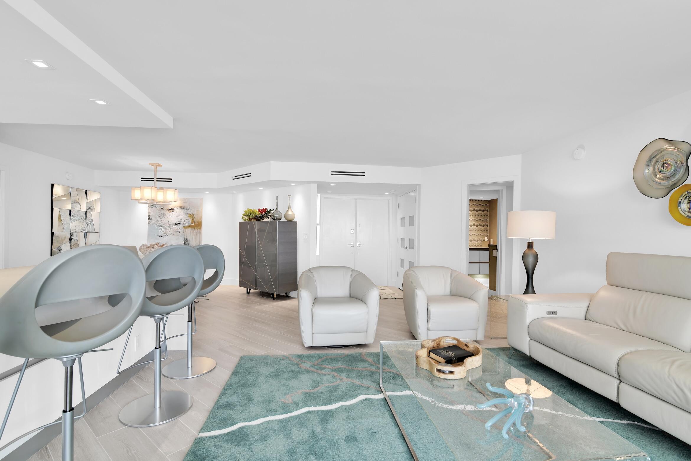 550 South Ocean Boulevard, Unit 1004 Boca Raton, FL 33432 - Photo 9 of 74 a living room with furniture and a table