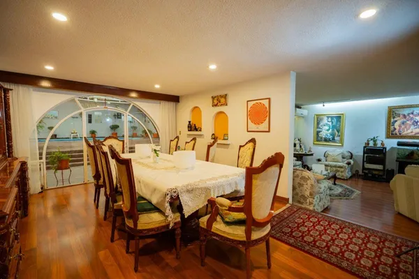 a dining room with furniture and wooden floor