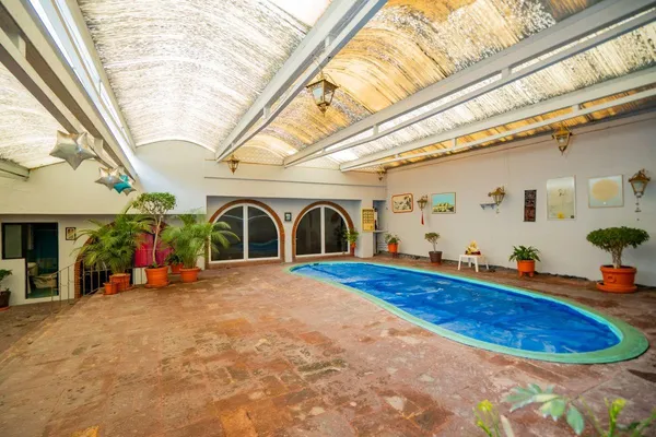 a swimming pool with outdoor seating and yard