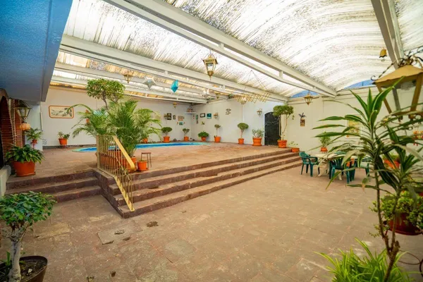 a house with potted plants in front of it