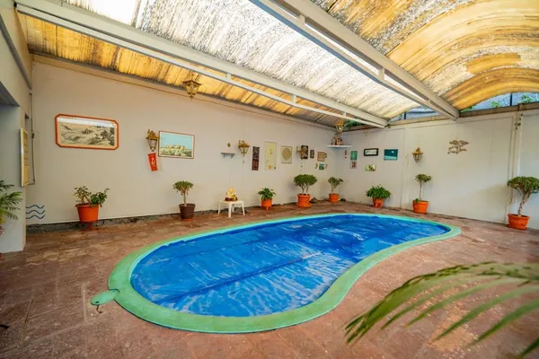 a living room with furniture a lamp and a large window
