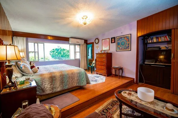 a bedroom with furniture and a window