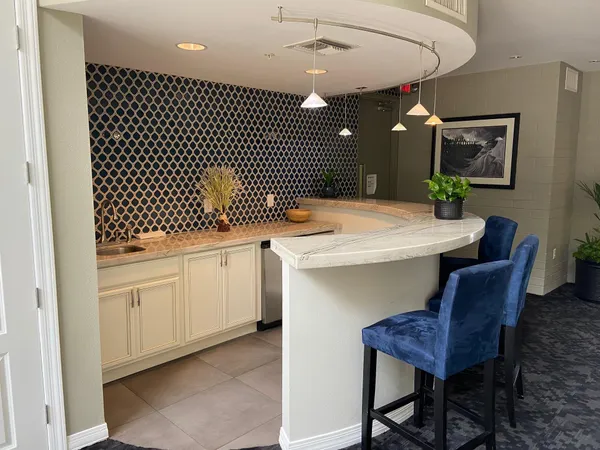 a kitchen with a sink cabinets and wooden floor