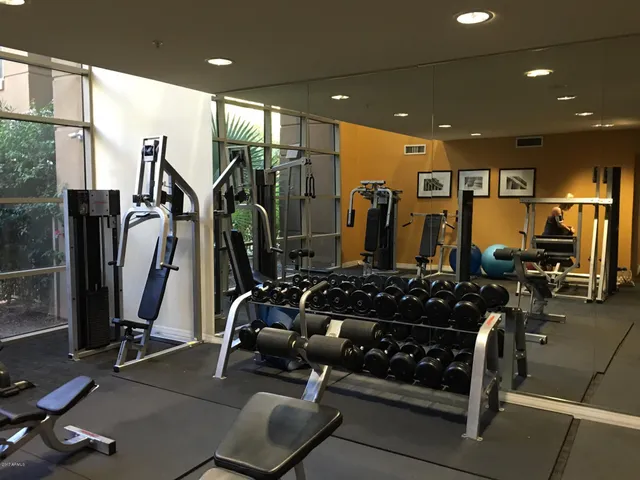 a room with gym equipment and a large window