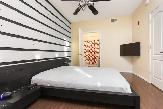 a bedroom with a bed and a flat screen tv