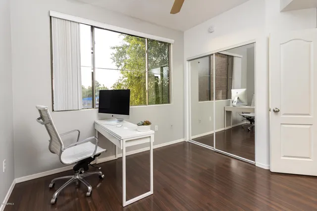 a workspace with wooden floor and white walls