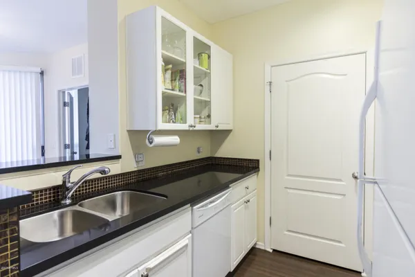 a kitchen with a sink and a refrigerator