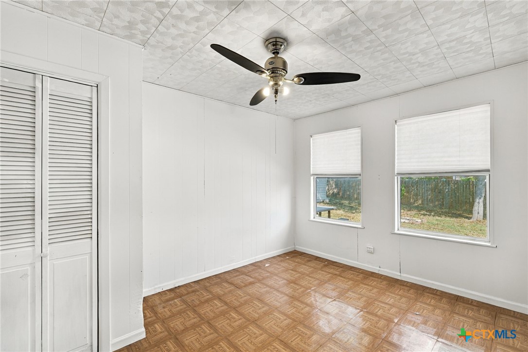 904 Kirk Street Taylor, TX 76574 - Photo 15 of 25 Bedroom 2 with updated lighting & fan, light & bright with closet.