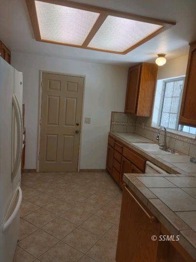 609 East Wilson Avenue Ridgecrest, CA 93555 - Photo 8 of 32 a view of a storage & utility room with refrigerator
