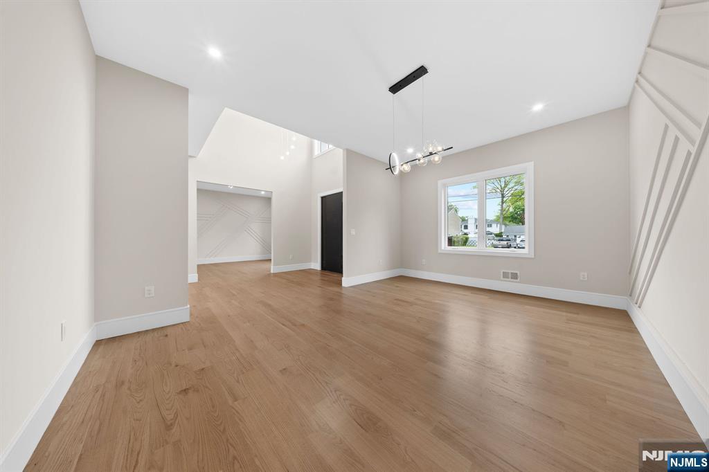 317 Edstan Way Paramus, NJ 07652 - Photo 13 of 48 an empty room with wooden floor and windows