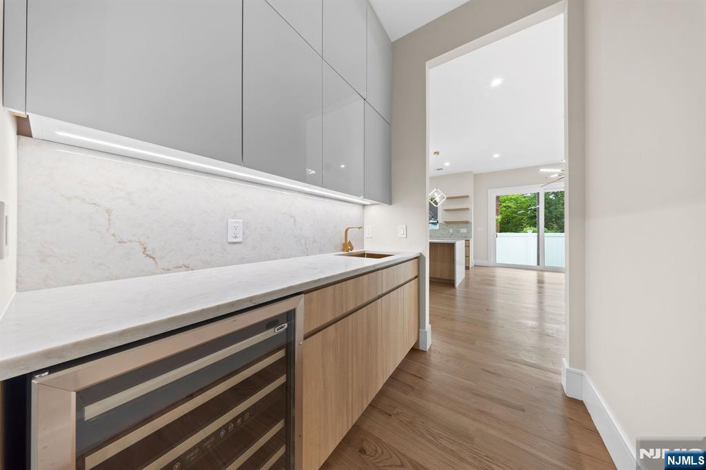 317 Edstan Way Paramus, NJ 07652 - Photo 15 of 48 a kitchen with a white cabinets wooden floor and a sink