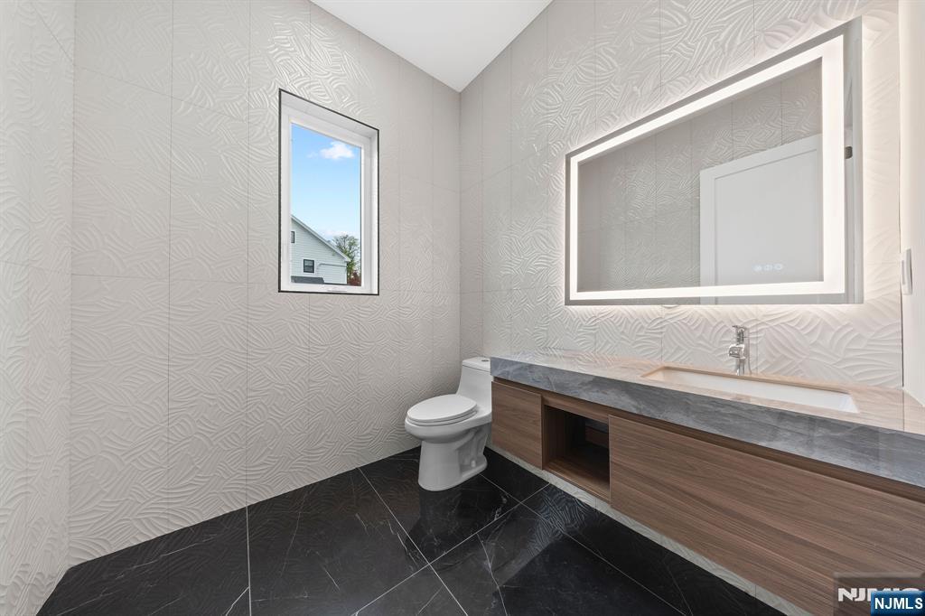 317 Edstan Way Paramus, NJ 07652 - Photo 16 of 48 a bathroom with a toilet sink and mirror