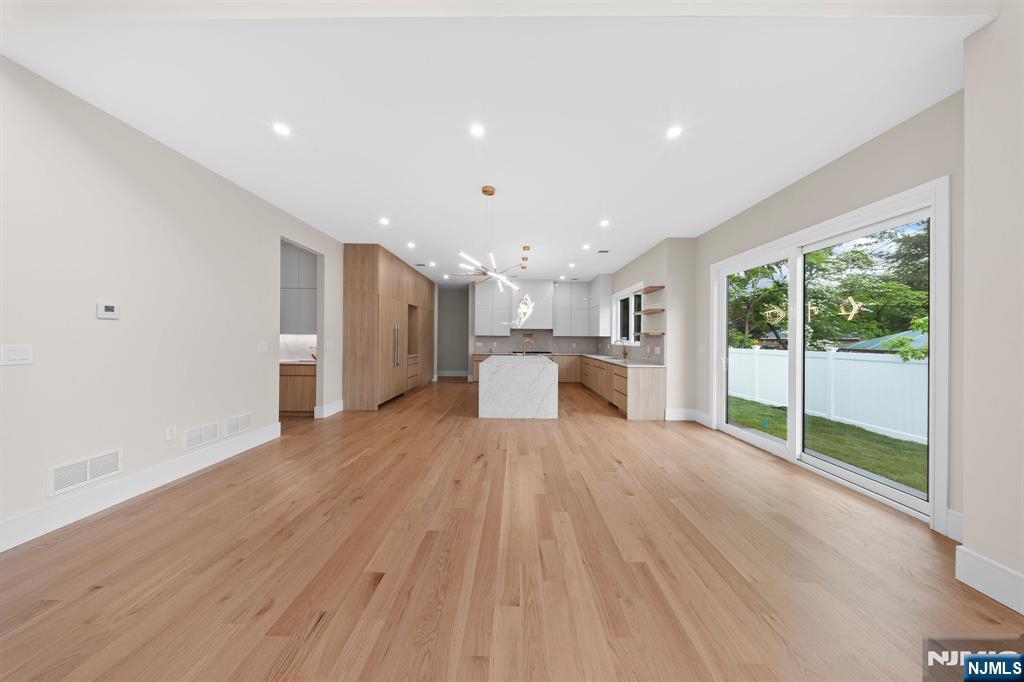 317 Edstan Way Paramus, NJ 07652 - Photo 19 of 48 a view of empty room with wooden floor and windows