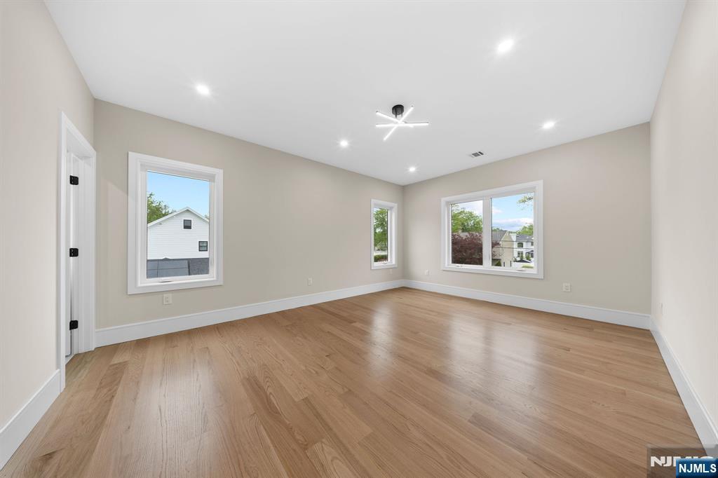 317 Edstan Way Paramus, NJ 07652 - Photo 23 of 48 an empty room with wooden floor and windows