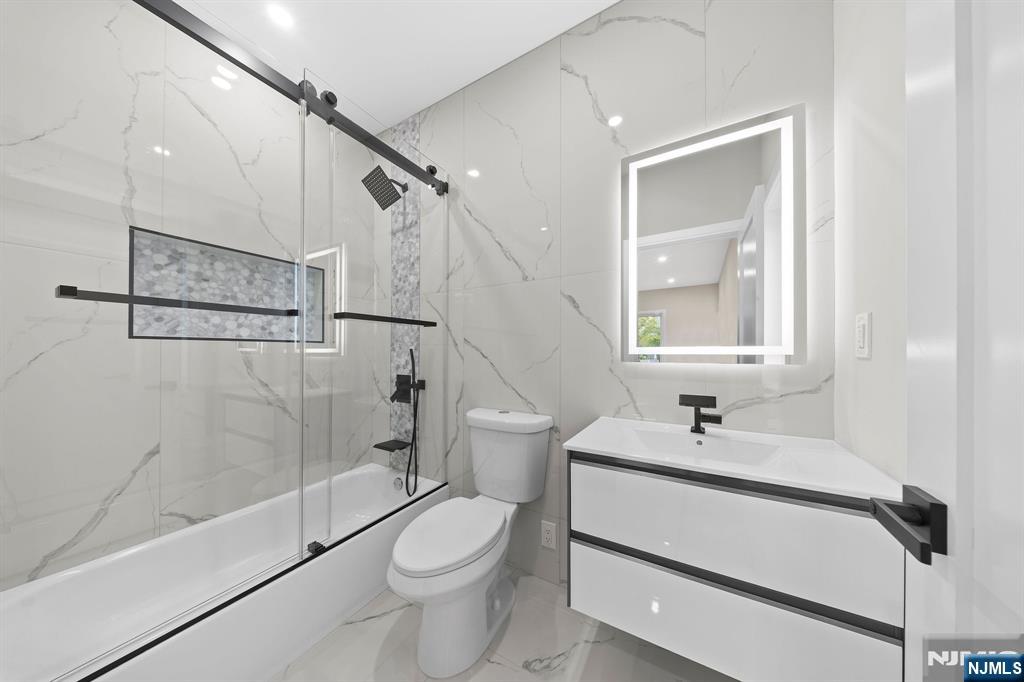 317 Edstan Way Paramus, NJ 07652 - Photo 24 of 48 a bathroom with a sink a toilet and shower
