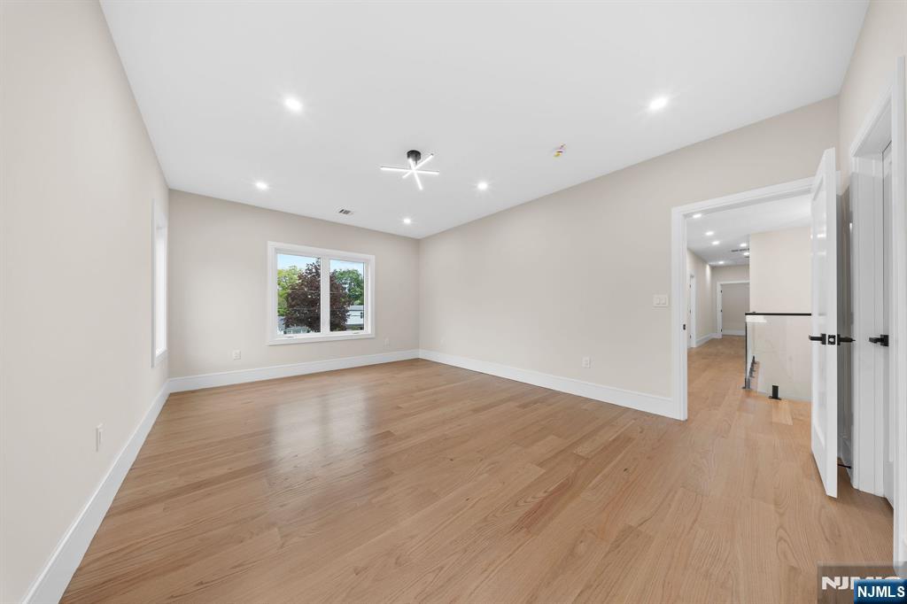 317 Edstan Way Paramus, NJ 07652 - Photo 25 of 48 wooden floor in an empty room with a window