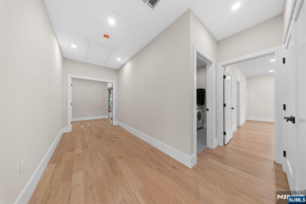 317 Edstan Way Paramus, NJ 07652 - Photo 26 of 48 a view of a hallway with wooden floor and staircase