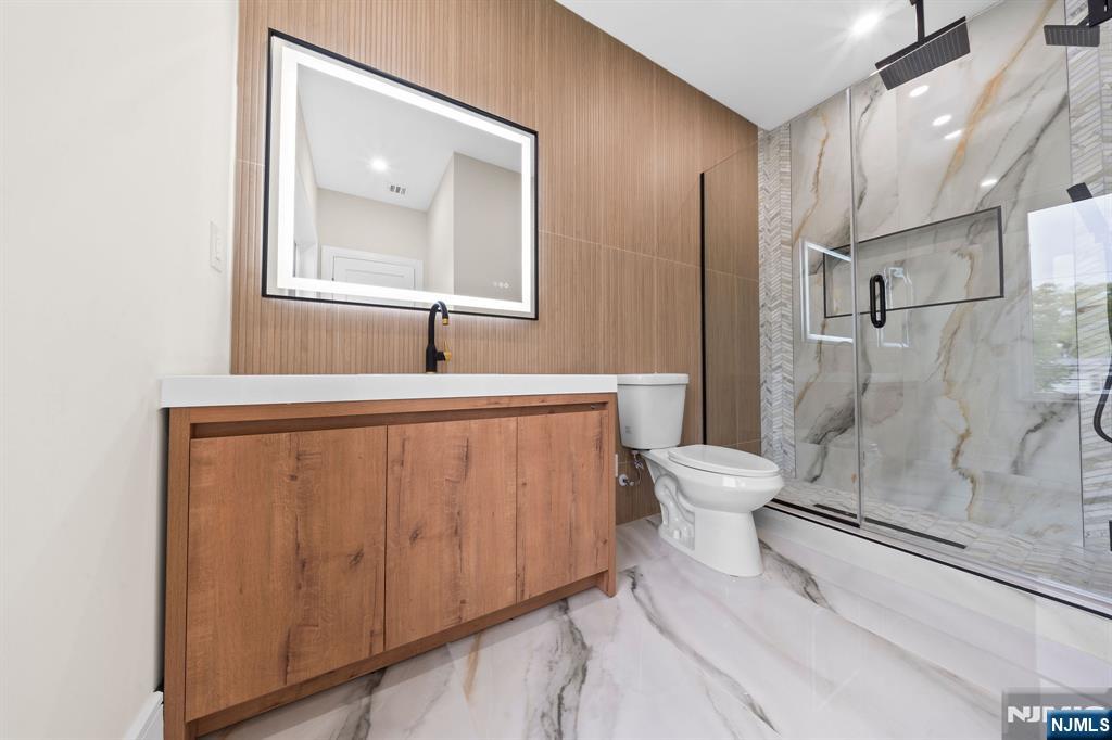 317 Edstan Way Paramus, NJ 07652 - Photo 30 of 48 a bathroom with a granite countertop sink toilet and shower