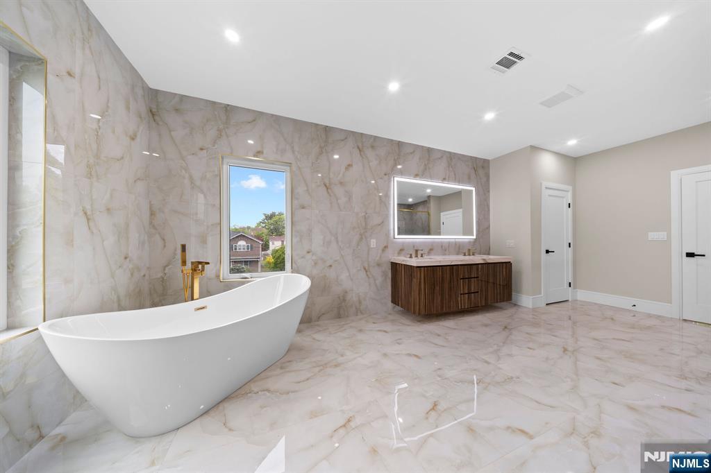 317 Edstan Way Paramus, NJ 07652 - Photo 36 of 48 a bathroom with a bathtub and a shower
