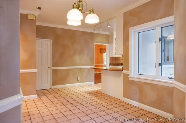 a view of a livingroom with wooden floor and kitchen space