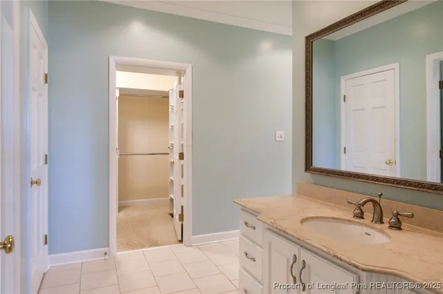 a bathroom with a shower sink and mirror
