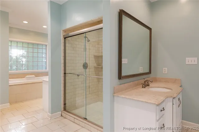 a bathroom with a sink vanity tub and a mirror