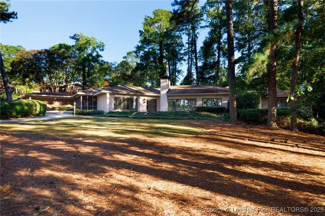 a view of a house with a large trees
