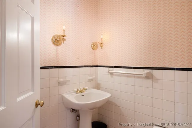 a bathroom with a sink a mirror and shower