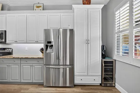 a kitchen with stainless steel appliances a refrigerator and cabinets