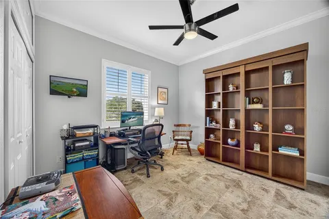 a view of a livingroom with workspace and a window