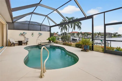 a swimming pool with lawn chairs