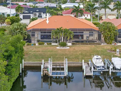 a aerial view of a house with swimming pool and a chairs