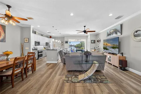 a living room with dining room and wooden floor
