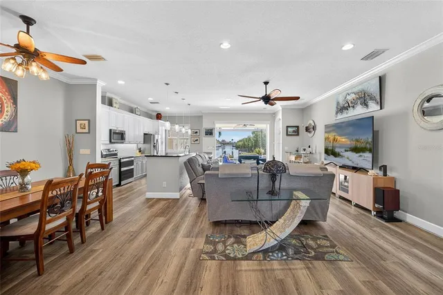 a living room with dining room and wooden floor
