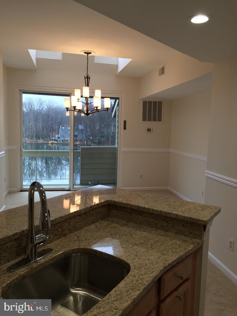 11242 Harbor Court, Unit 1242 Reston, VA 20191 - Photo 5 of 8 a kitchen with a sink a counter top space and cabinets