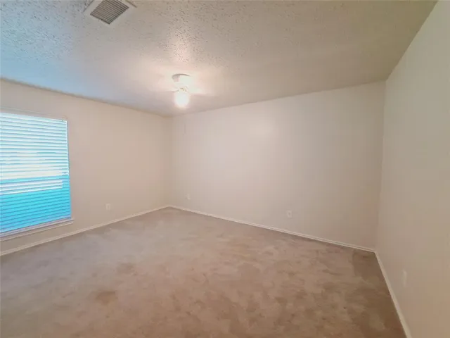 an empty room with a empty space and windows